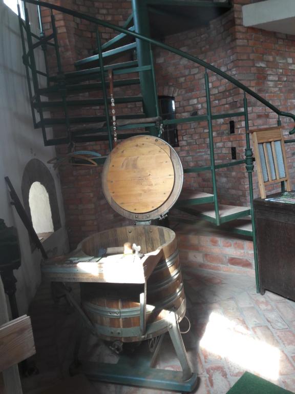 a room with a barrel and a table and stairs at Wasserturm Angermünde in Angermünde