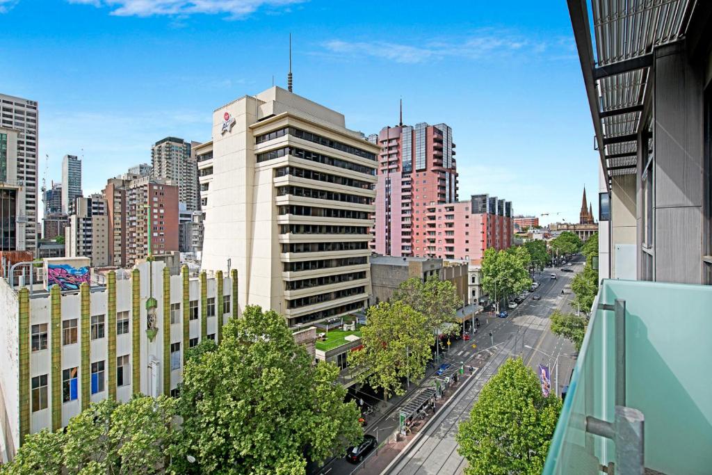 a city street with tall buildings and buildings at Melbourne CBD Central Apartment Hotel in Melbourne
