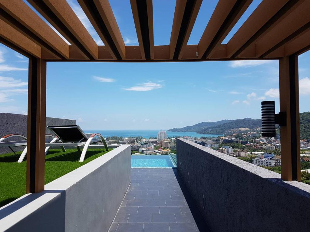 a view from the balcony of a house with a swimming pool at Searocco Phuket in Patong Beach