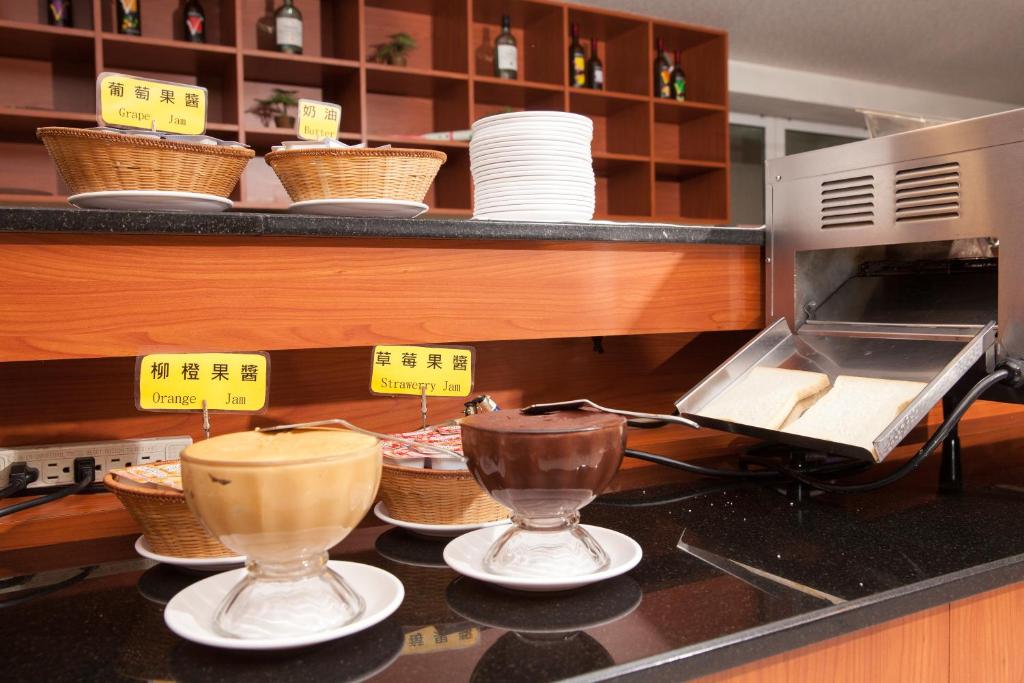 a kitchen with a counter with bowls and baskets at F Hotel - Chiayi in Fanlu