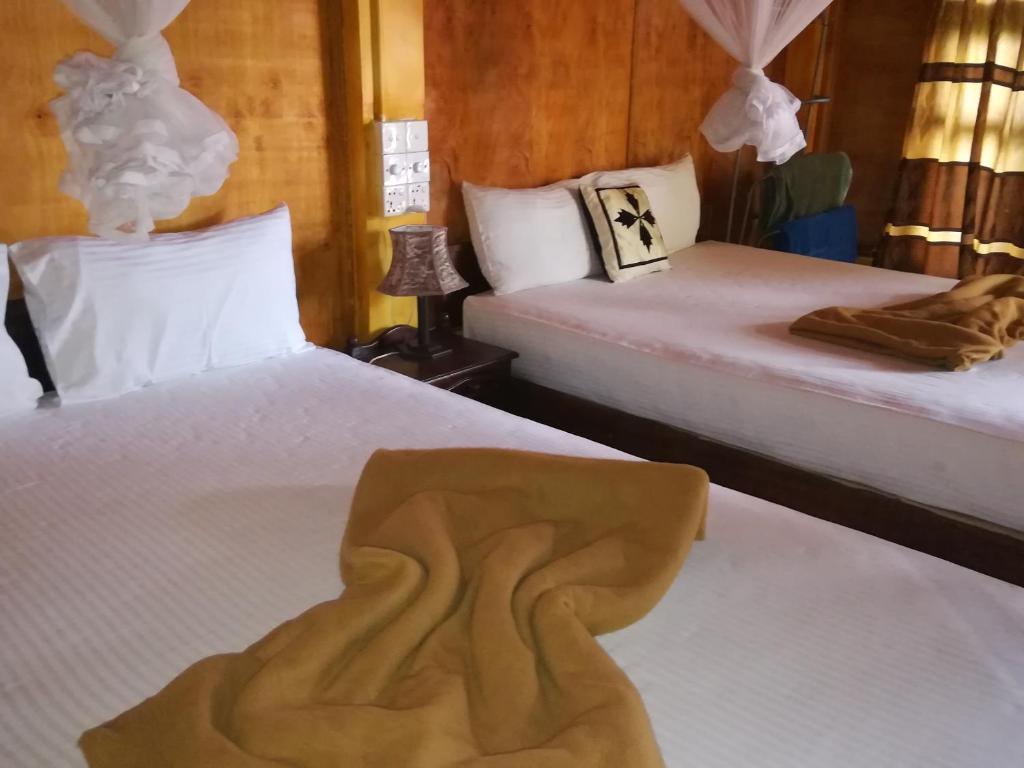 Postel nebo postele na pokoji v ubytování Sigiriya River Side Resort