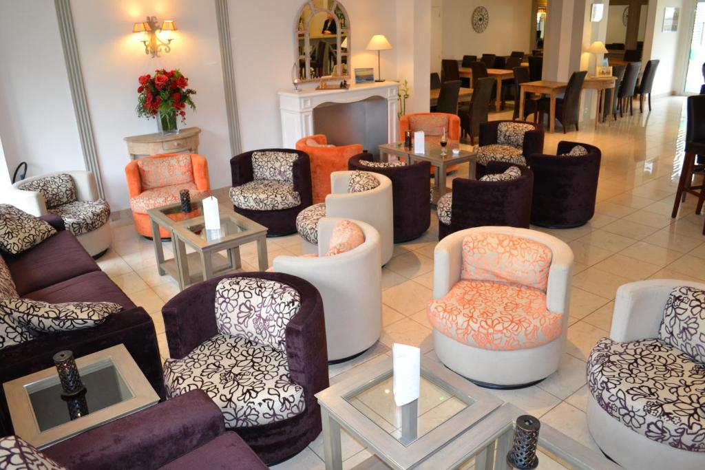 a room with many chairs and tables in a store at Almoria Hôtel & SPA in Deauville
