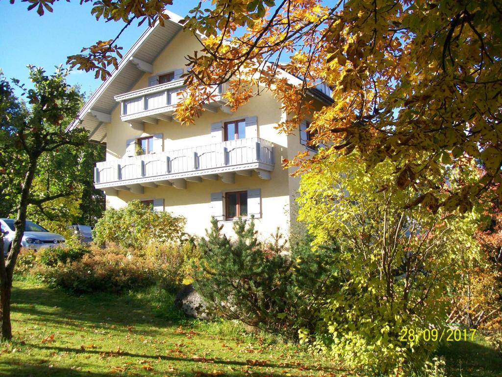 a white building with a balcony on the side of it at Maier Pension in Bayerisch Eisenstein