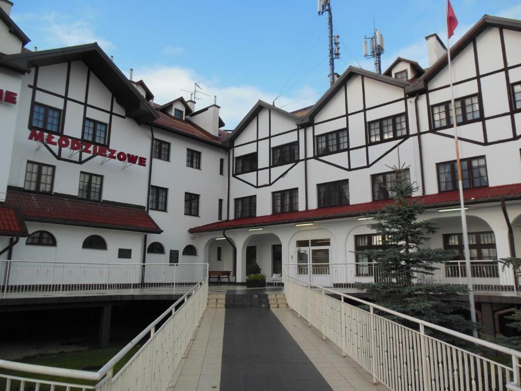 a large white building with a walkway in front of it at Szkolne Schronisko Młodzieżowe w Gdańsku School Youth Hostel in Gdańsk in Gdańsk