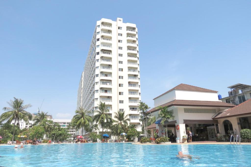 a swimming pool in front of a tall building at View Talay 1B Holidays in Pattaya South