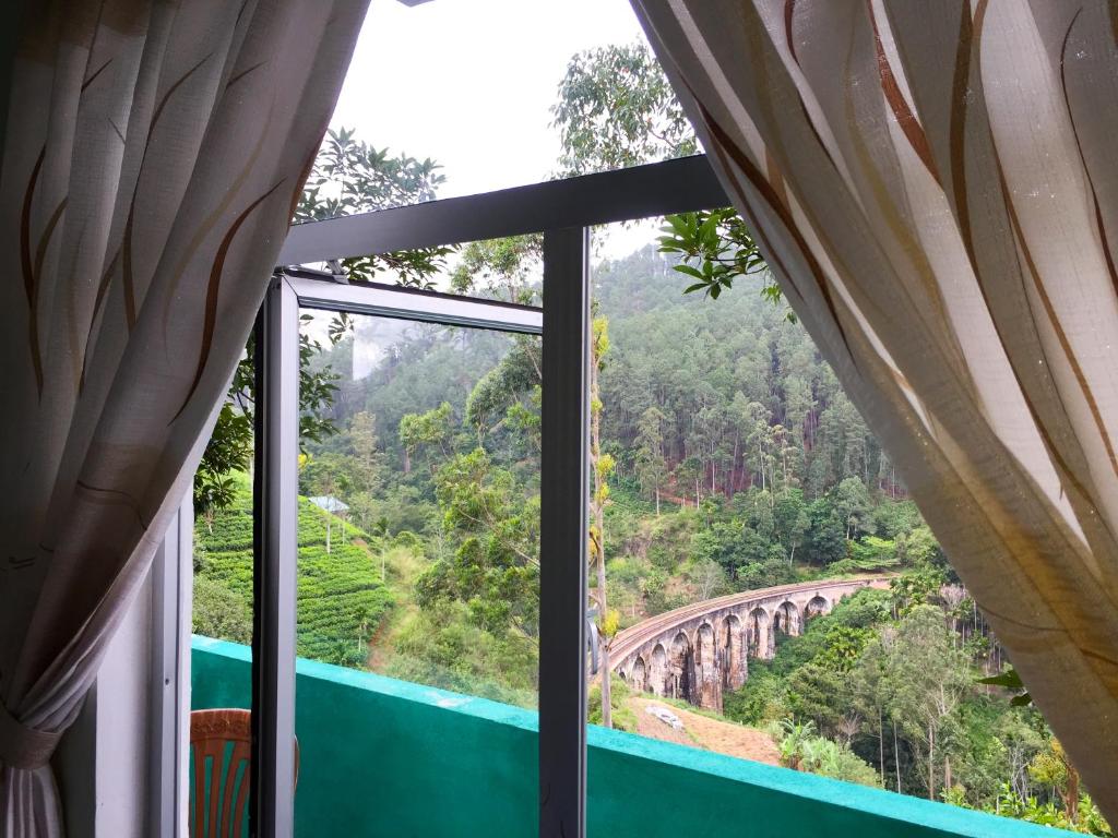 a window in a room with a view of a bridge at 9 Arch view rest inn in Ella
