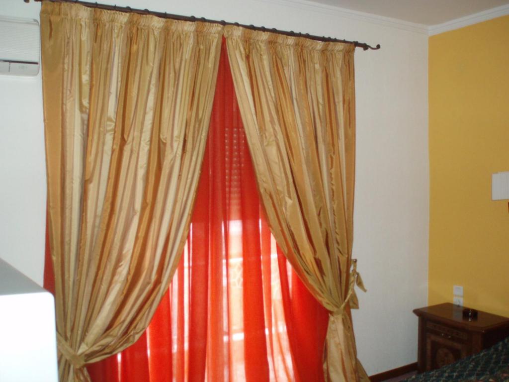 A bed or beds in a room at Hotel Orfeas