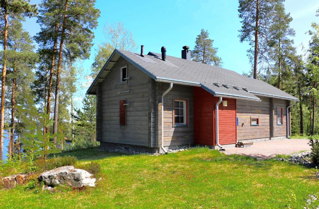 a small house on a hill in the woods at Rauhalahti Holiday Homes in Kuopio