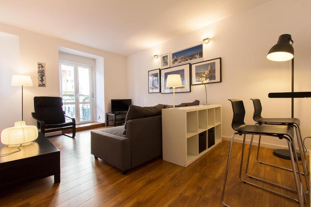 a living room with a couch and a chair at Typical Tailor Made Flat in Central Graça in Lisbon