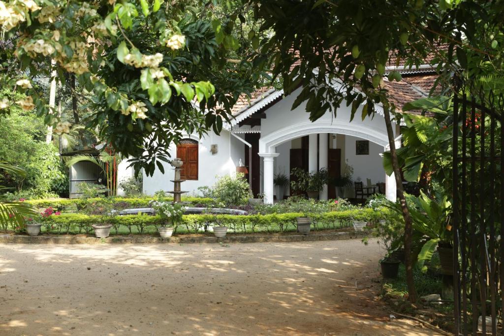 a house with a garden in front of it at Kithulvilla Holiday Bungalow in Kitulgala