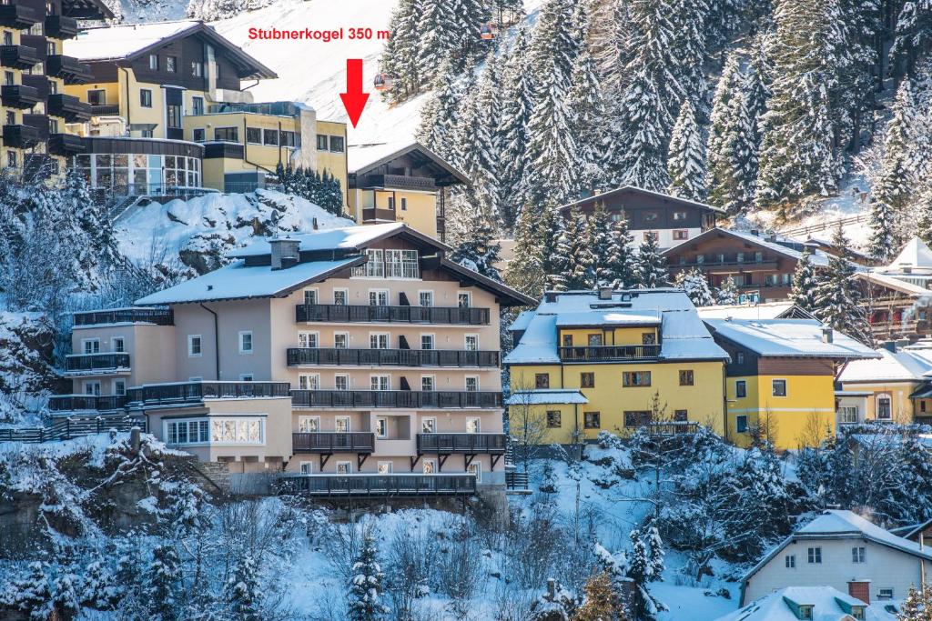 a group of buildings on a snow covered mountain at Alpenhof by AlpenTravel in Bad Gastein
