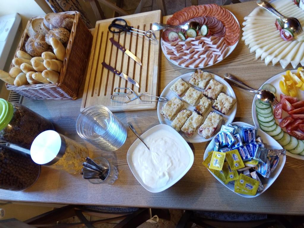 a table topped with plates of food and desserts at Hotel Orix in Jáchymov