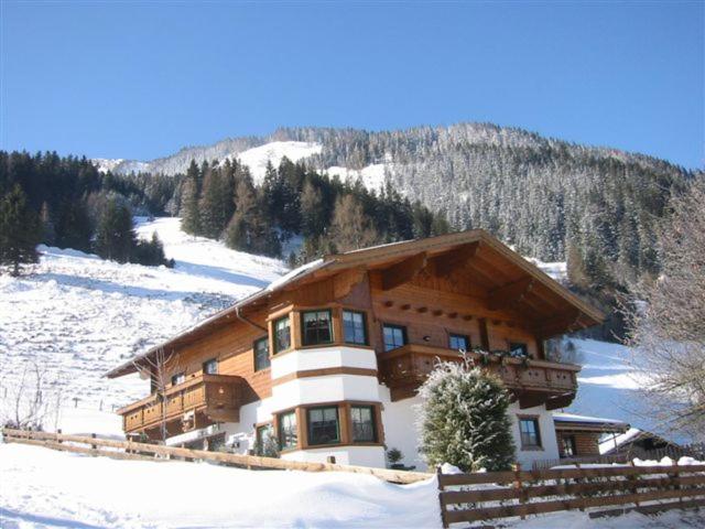 a large building on a snow covered mountain at Haus Gaby Stöckl in Rauris