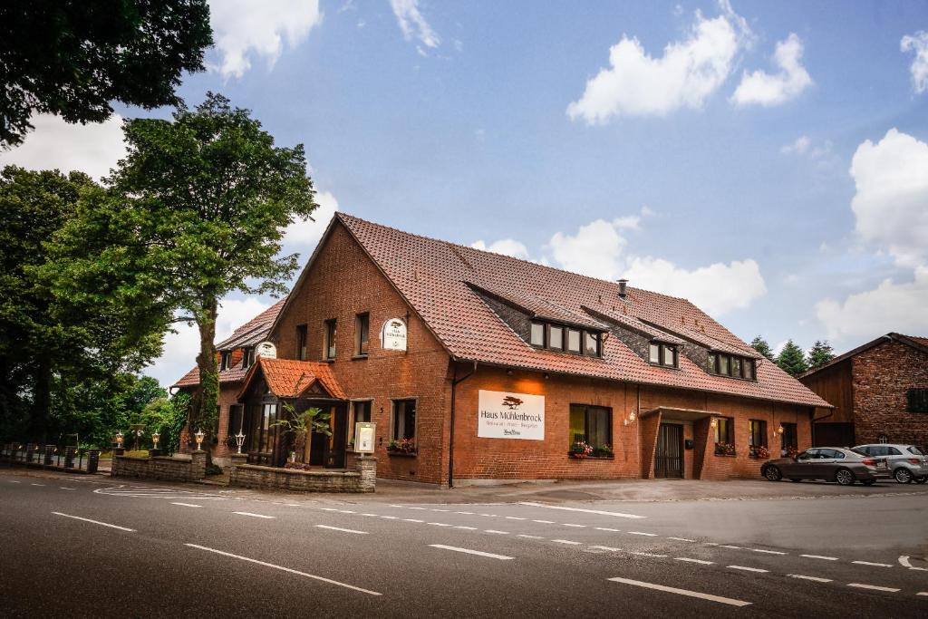 a large brick building on the side of a street at Haus Mühlenbrock in Schermbeck