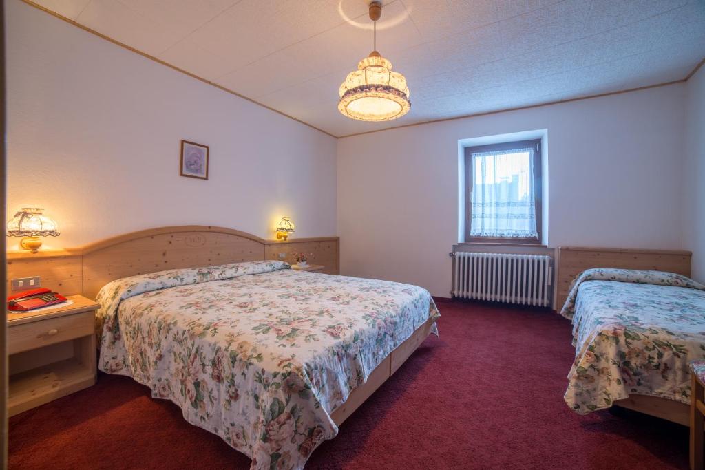 Postel nebo postele na pokoji v ubytování Hotel Bertoldi