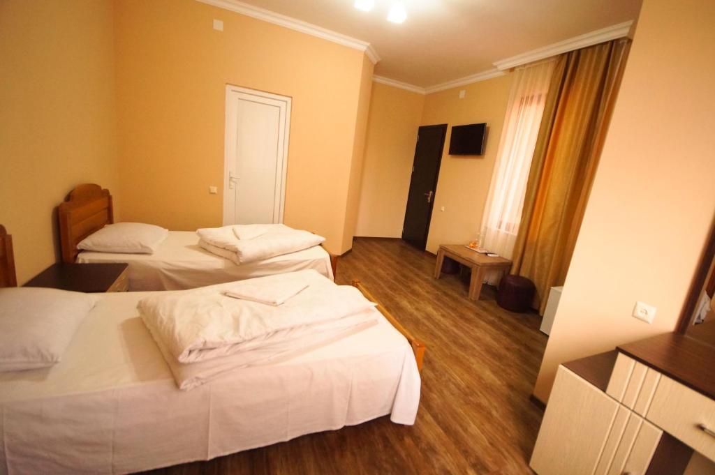 Postel nebo postele na pokoji v ubytování Marani Hotel
