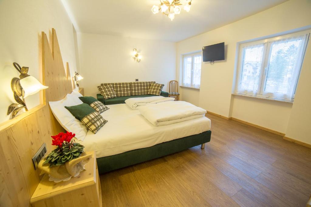 Postel nebo postele na pokoji v ubytování Hotel Bertoldi