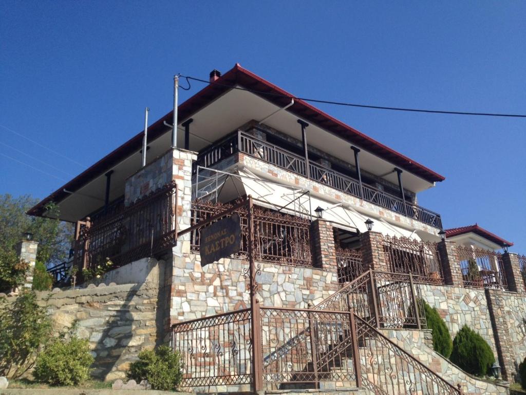 a building with balconies on the side of it at Guesthouse Kastro in Edessa