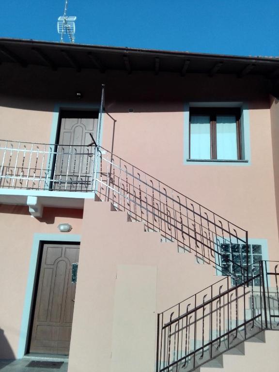 a building with two balconies and a staircase on it at Appartamento Ormeni in Cardano al Campo