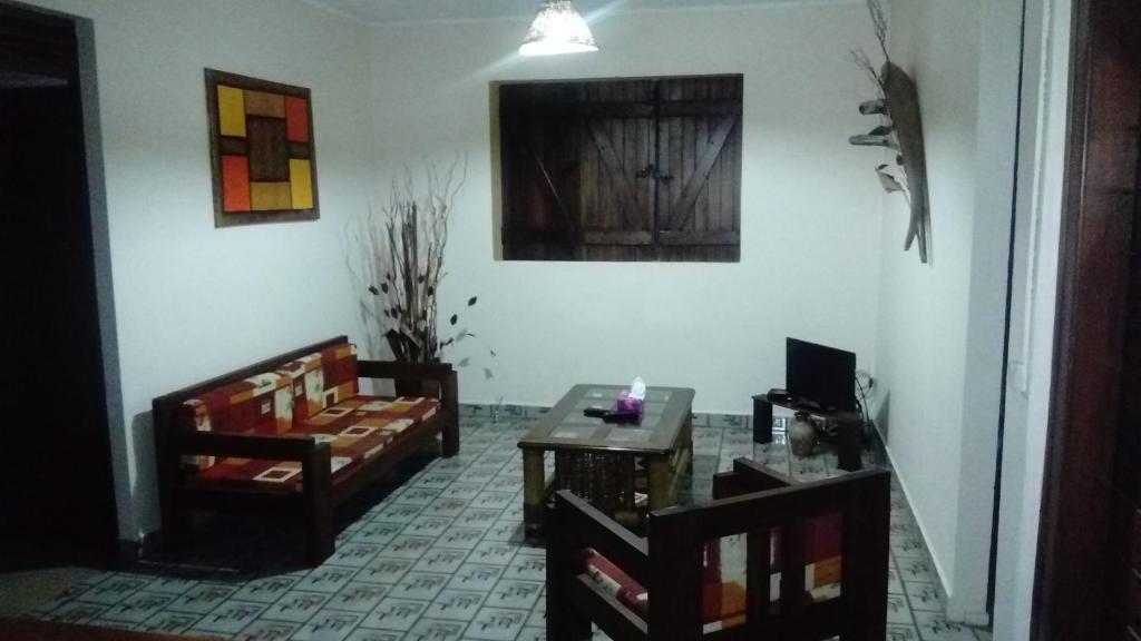 a living room with two chairs and a table at Habitation Fouyapen in Sainte-Anne