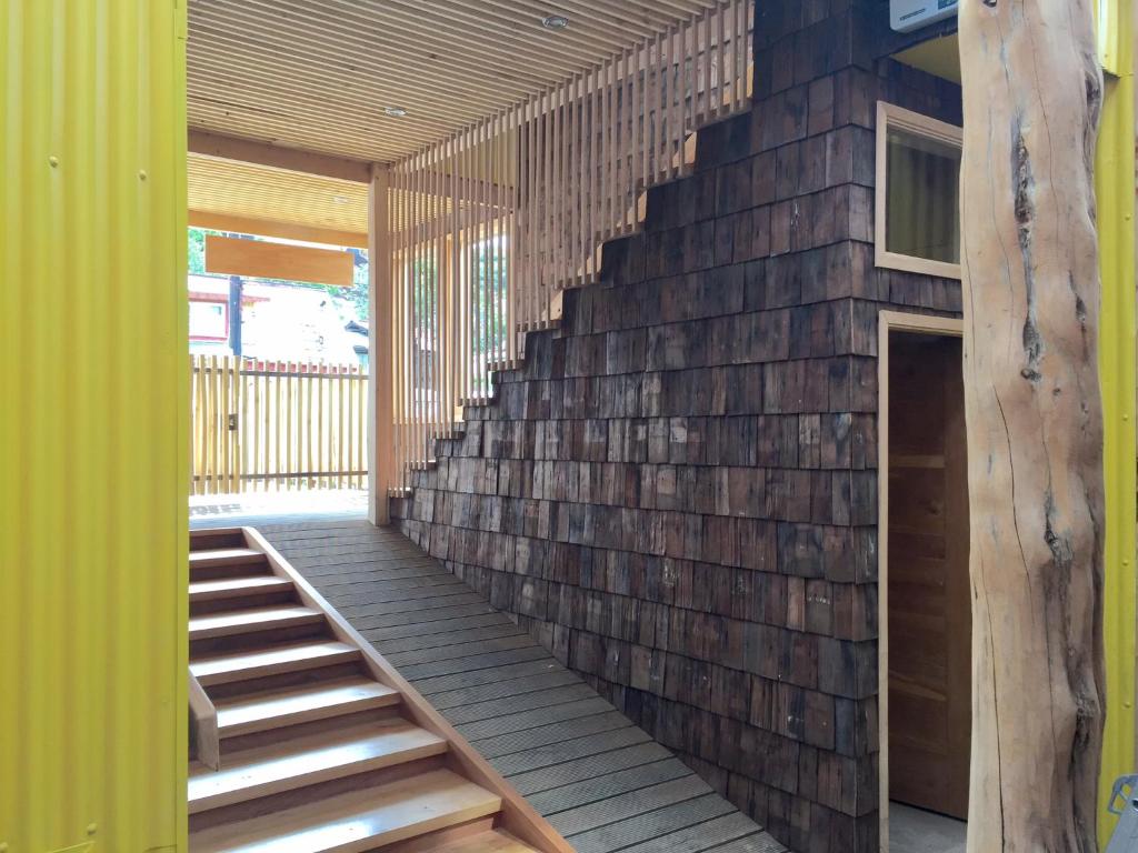a brick wall with a staircase in a house at Palafito Azul Apart Hotel in Castro