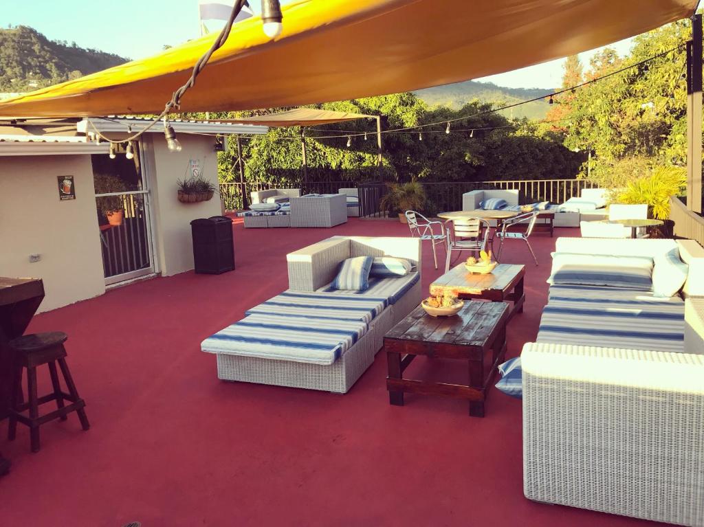 a group of chairs and umbrellas on a patio at Palmira Hostel in Tegucigalpa