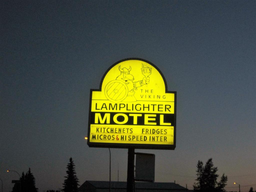 a large yellow sign for a laundromater motel at Viking Lamplighter Motel in Viking