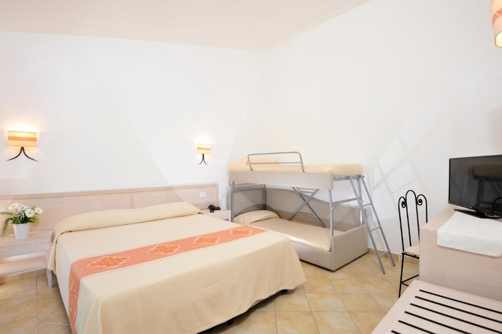Postel nebo postele na pokoji v ubytování Hotel Baia Del Porto