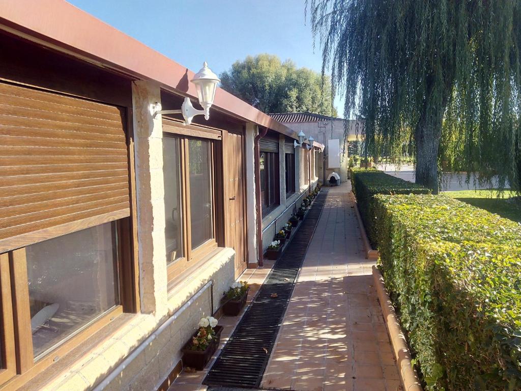 a long sidewalk next to a building with a street at Villamercedes Estudio 3 in Salamanca