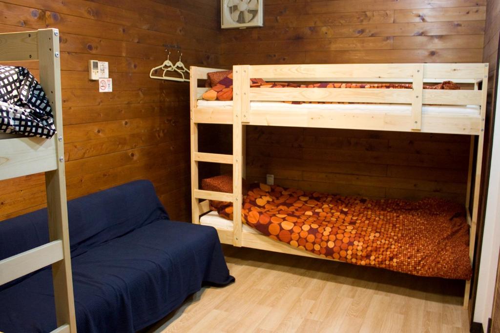 a room with two bunk beds and a bed at Tsukiji Hostel Wakayama 3 in Wakayama