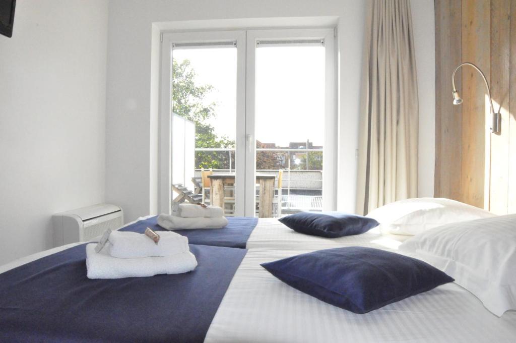 Postel nebo postele na pokoji v ubytování Hotel Aan Zee