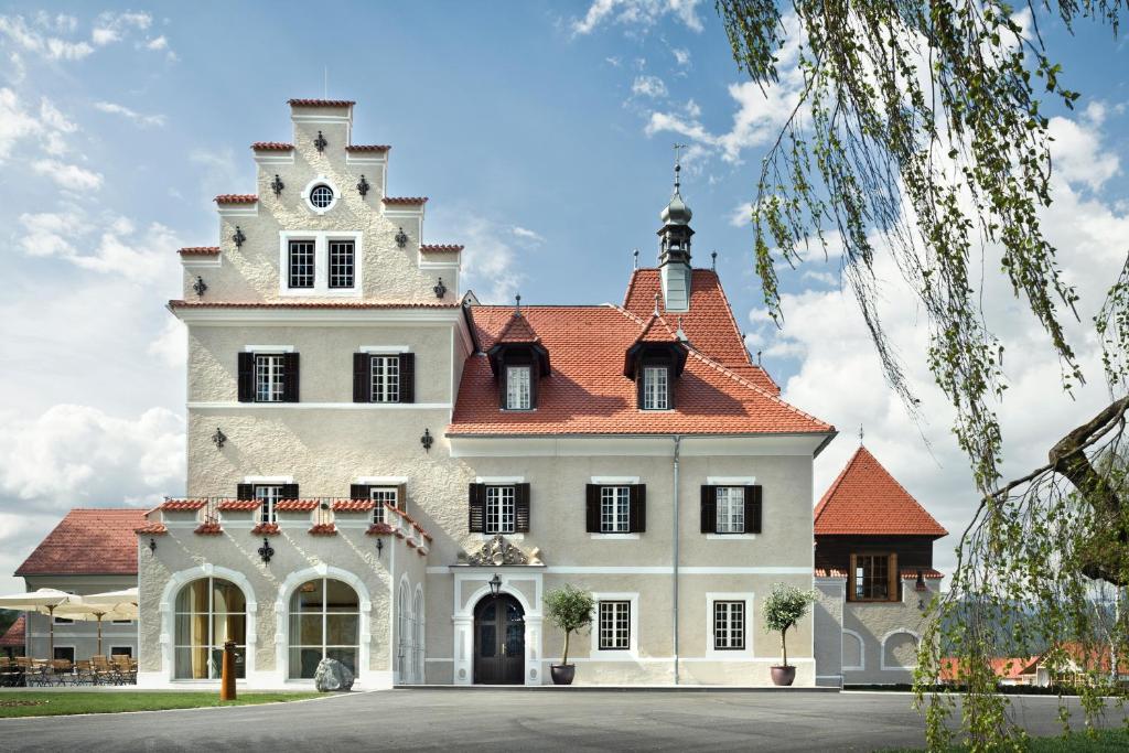 a large white house with a red roof at G'Schloessl Murtal in Großlobming