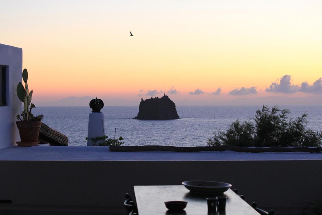 a view of the ocean at sunset from a balcony at Case Vacanza Gia.no in Stromboli