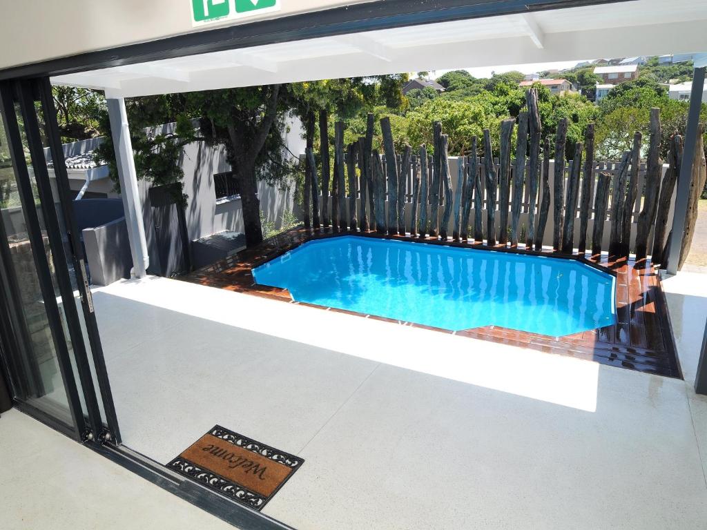 a swimming pool in a house with a fence at Inverell Station by The Oyster Collection in Kenton on Sea