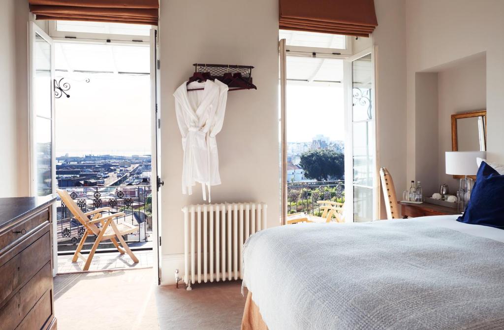 a bedroom with a bed and glass doors with a view at Albion House at Ramsgate in Ramsgate