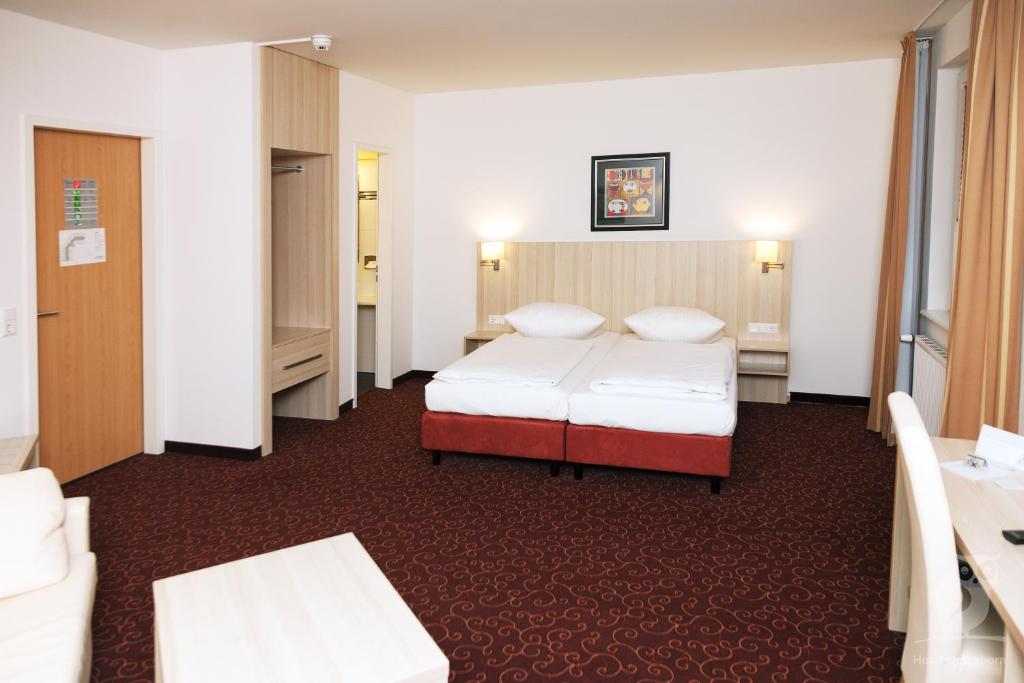 Postel nebo postele na pokoji v ubytování Hotel Quickborn & Gästehaus Hesse