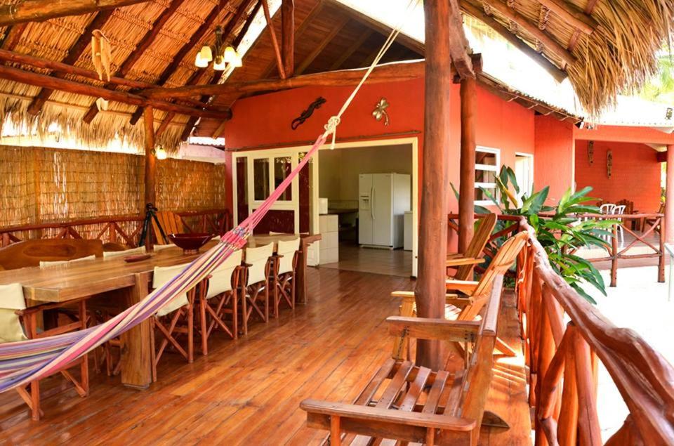 a room with a hammock and a table and chairs at Villas la Paz in Playa Conchal