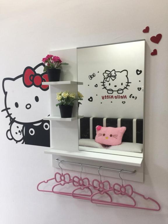 a mirror with a hello kitty sticker on a wall at Cameron DreamWorld Apartment @ Golden Hill in Cameron Highlands
