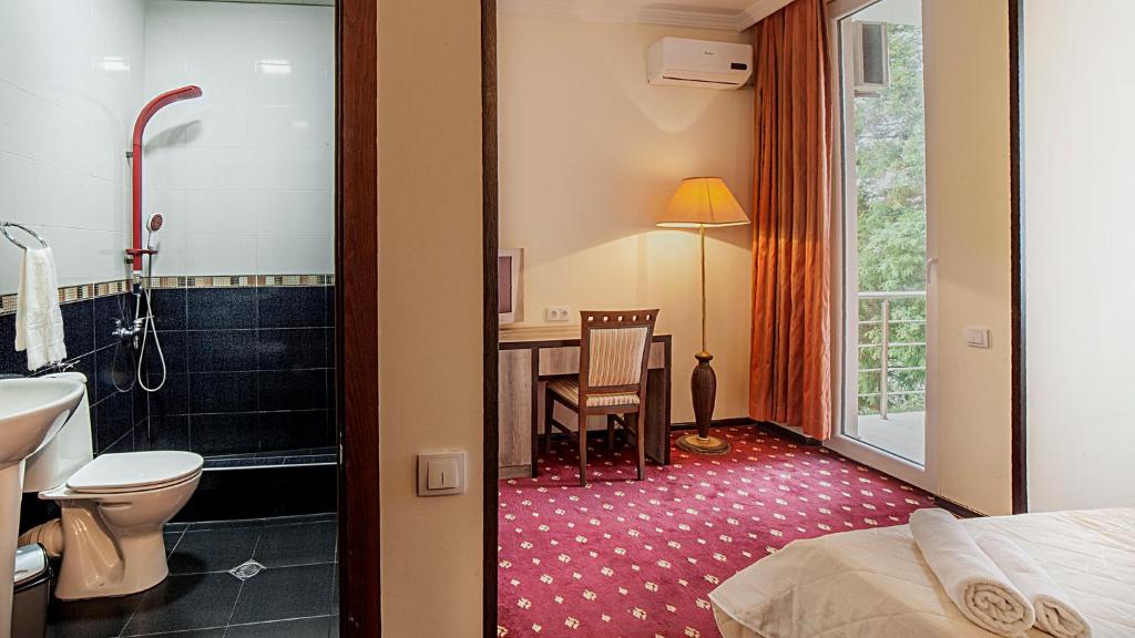 Postel nebo postele na pokoji v ubytování Orange Hotel