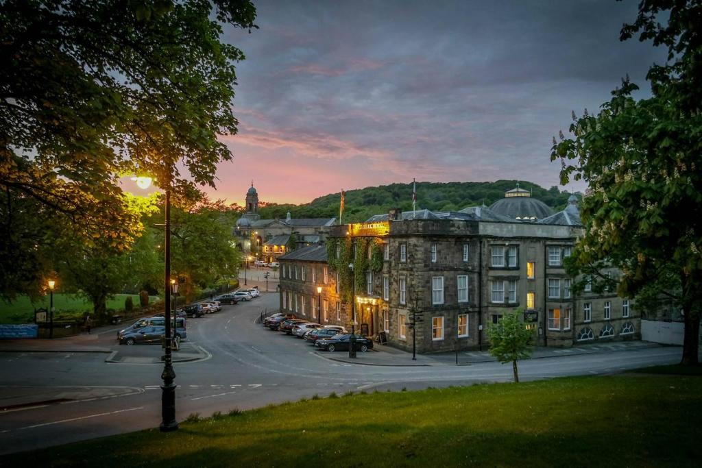 a city street with buildings and trees at Old Hall Hotel in Buxton