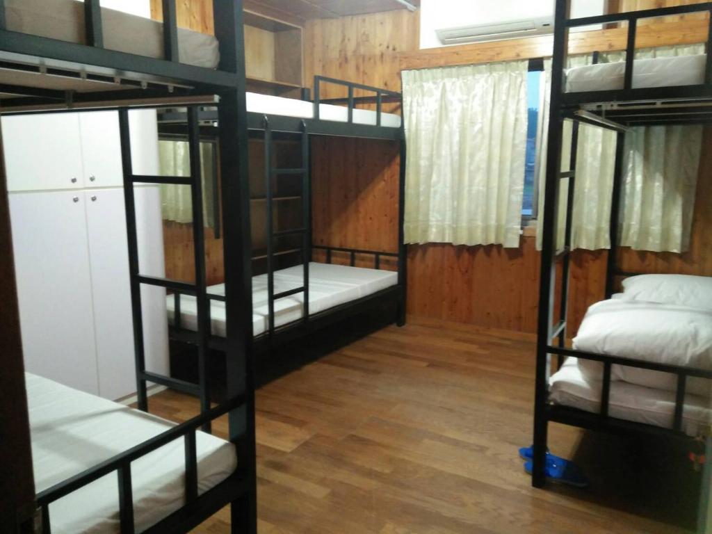 Zimmer mit 4 Etagenbetten in einem Zimmer in der Unterkunft Yes, Sir Homestay in Insel Nangan
