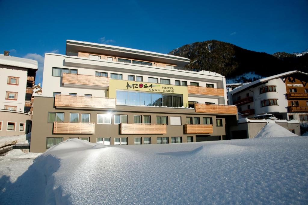 a building with a pile of snow in front of it at Hotel Garni Arosa in Ischgl