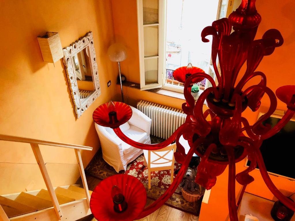 a red chandelier in a room with a window at Storico Loft nel Cuore di Lucca in Lucca