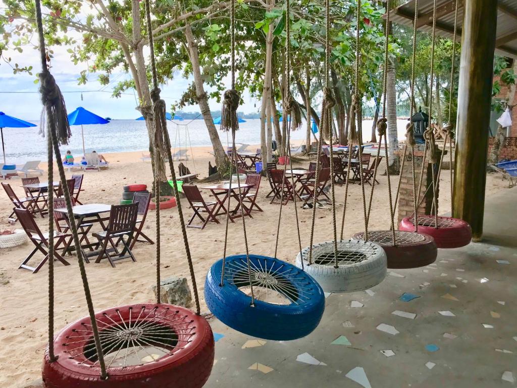 a group ofokedoked tires on the beach with tables and chairs at Vung Bau Resort in Phú Quốc