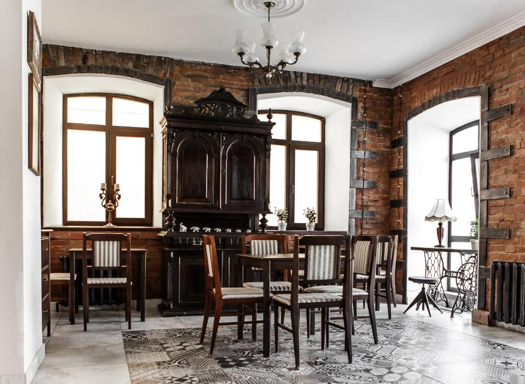 a dining room with a table and chairs at Brick Walls Hotel in Omsk