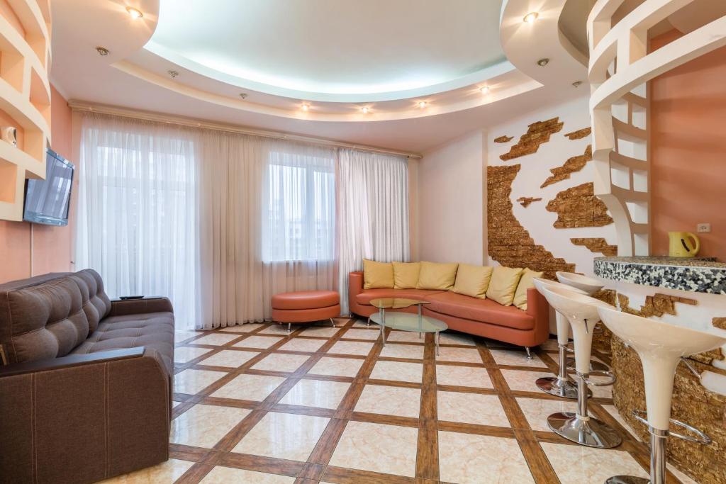 a living room with a couch and a table at Lux near Most City with panoramic windows in Dnipro