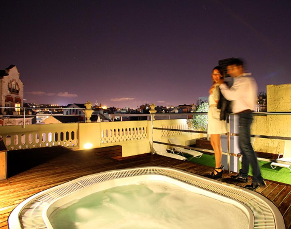 a man and a woman standing on a balcony at Ciutat Vella in Barcelona