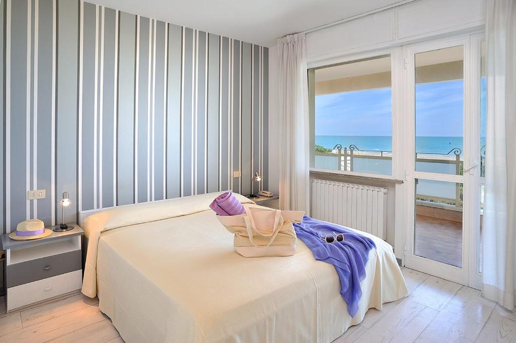 Ένα ή περισσότερα κρεβάτια σε δωμάτιο στο Residence Riccione Beach Apartments