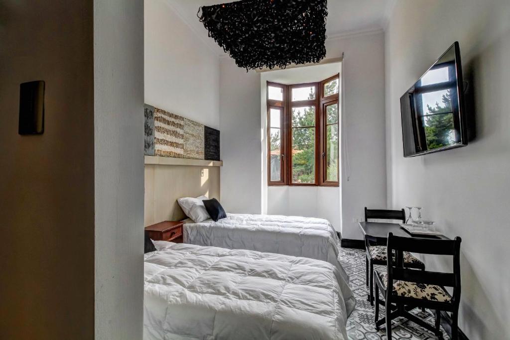 Postel nebo postele na pokoji v ubytování Casa Puente Hotel Boutique