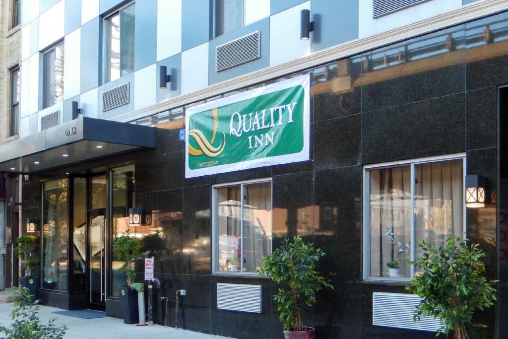 a building with a sign for a quality way at Quality Inn near Sunset Park in Brooklyn
